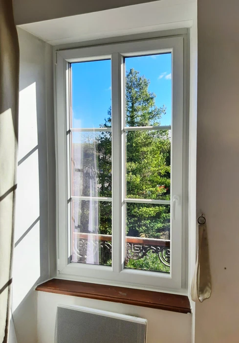 Fenêtre française double vantail en PVC blanc, petits bois intégrés, vitrage double, ouvrant à la française avec poignée espagnolette